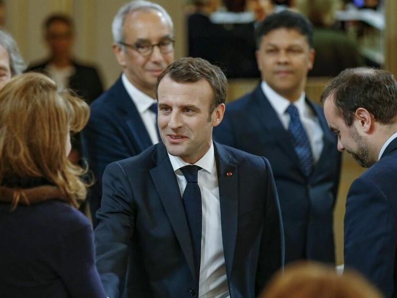 French President Emmanuel Macron shakes hands with French philospher Monique Canto-Sperber  (L) prior to a meeting with some 60 intellectuals as part of the "Great National Debate" on March 18, 2019, at the Elysee Palace in Paris. (Photo by Michel EULER / POOL / AFP)
